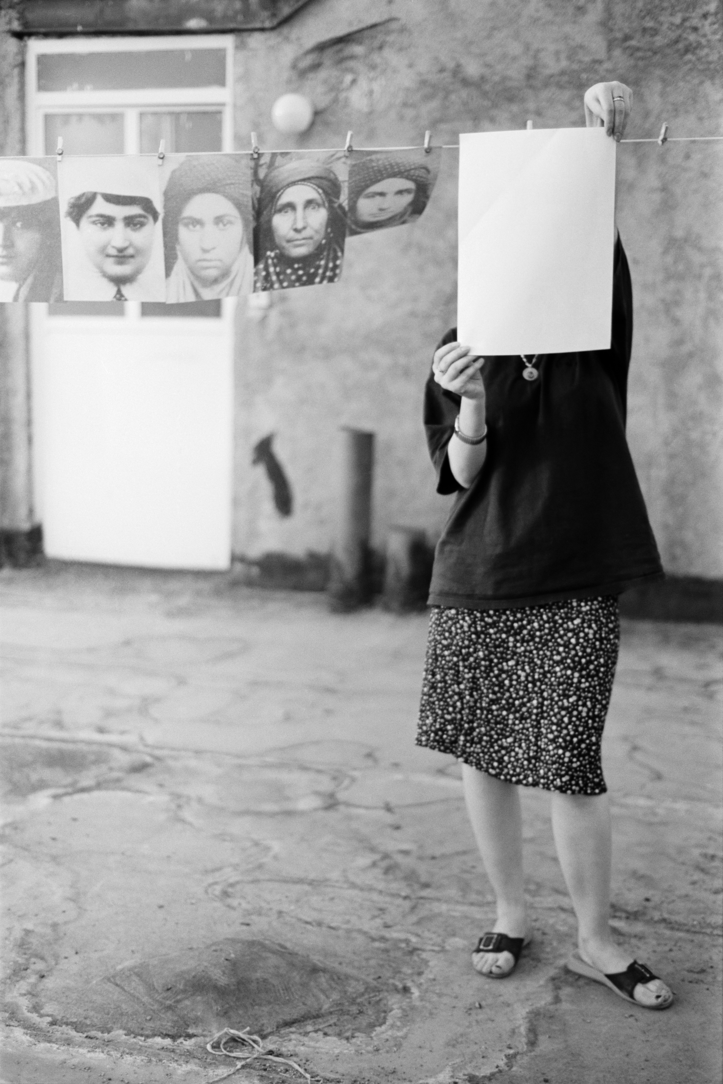 Zanjir, Person Holding Archival Photograph as Mask — Amak Mahmoodian