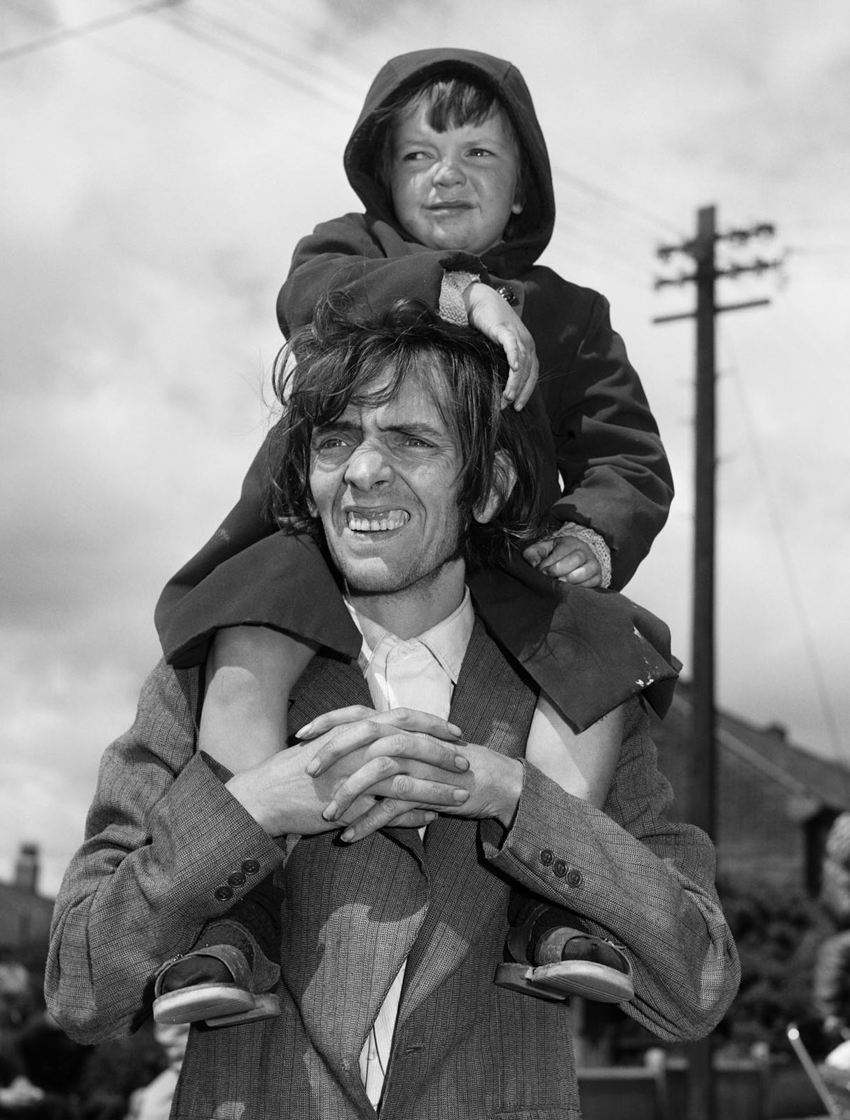 Father and Son Watching a Parade — Chris Killip, 1980