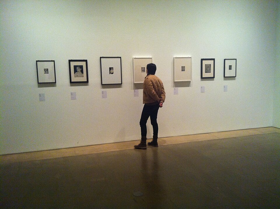 Visitor viewing Claude Cahun self-portraits at the Palau de la Virreina exhibition, Barcelona, 2012
