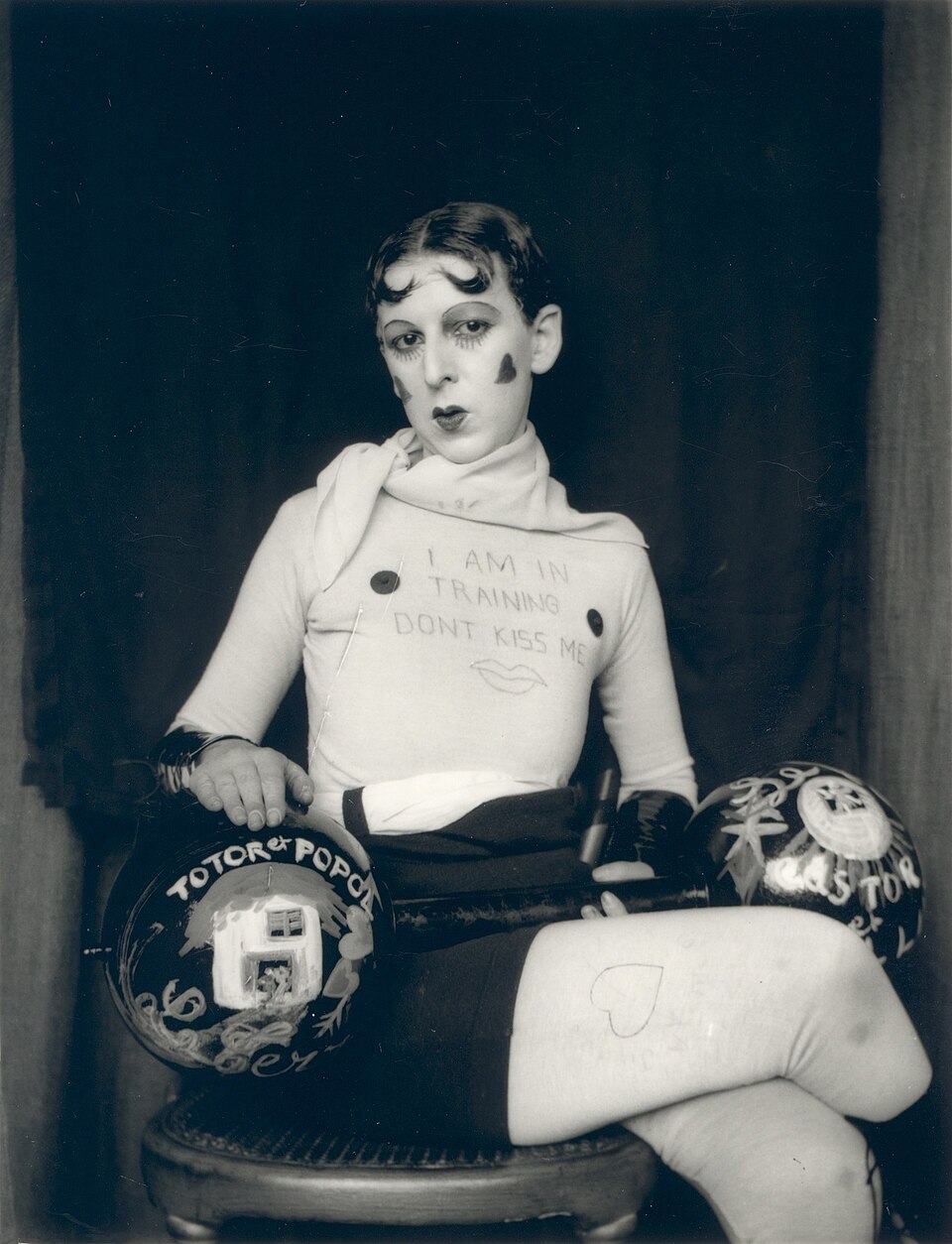 Claude Cahun self-portrait wearing a shirt reading I Am in Training Don't Kiss Me, c. 1927