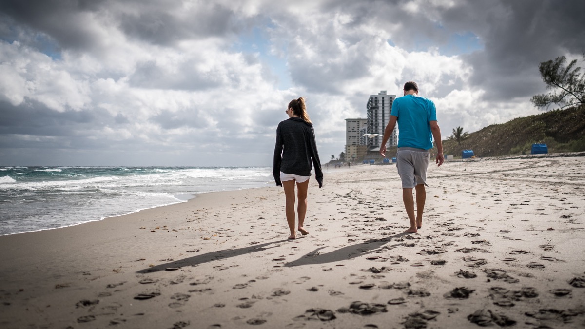 Color street photograph of a relaxing day at a Florida beach, evoking the saturated tones of Manos's American Color work