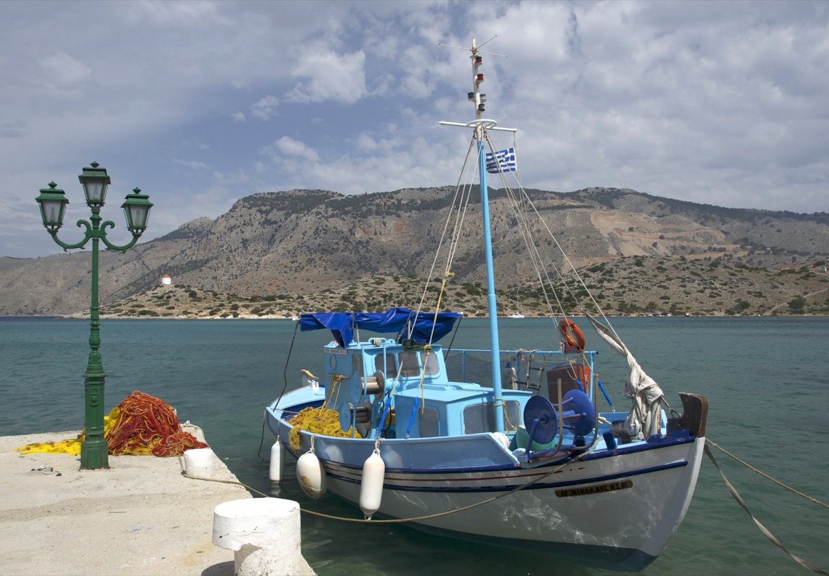 Colorful fishing boat in Panormitis harbor, Symi, Greece, reflecting the vivid Mediterranean light and geometry Manos sought