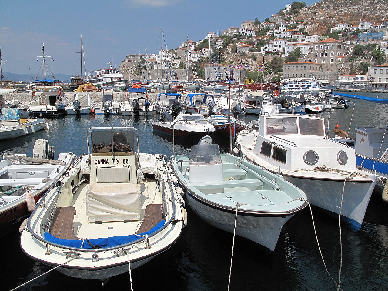 The bustling harbor of Hydra island, Greece, with its characteristic architecture and waterfront life