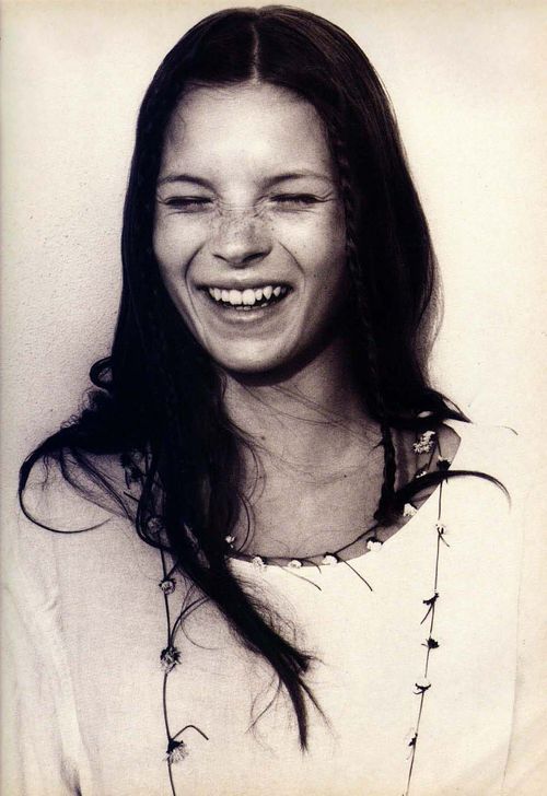 Kate Moss laughing on the beach at Camber Sands, photographed by Corinne Day, 1990
