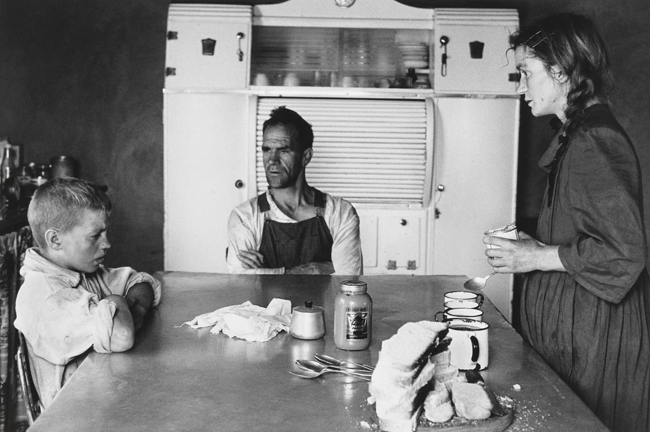 A Plot-holder, His Wife and Their Eldest Son at Lunch, Wheatlands, Randfontein, 1962 — David Goldblatt