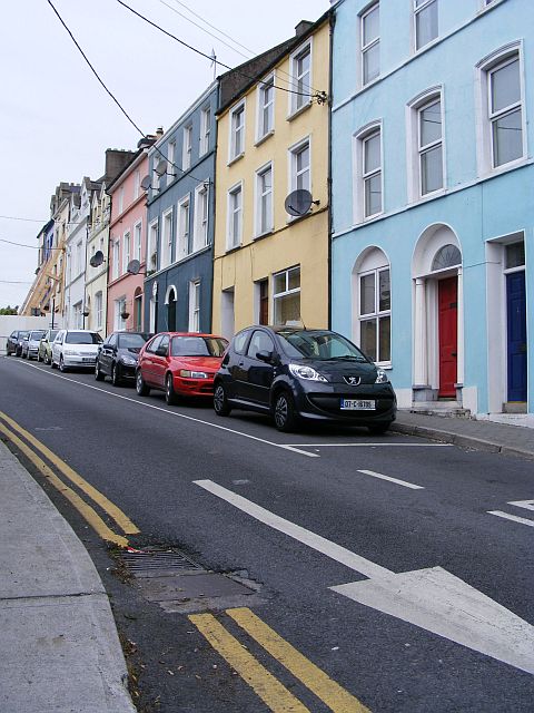 Colourful terraced houses on Harbour Hill, Cobh — the kind of close-knit streetscape that defines the community DuBois documented