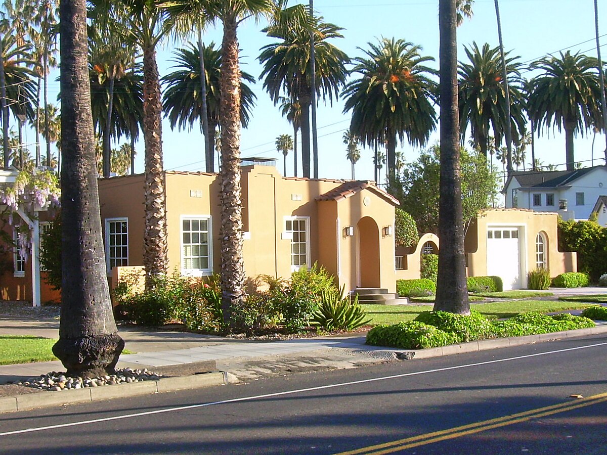 Palm tree lined suburban street in San Jose, California, evoking the sun-drenched landscapes of Henry Wessel