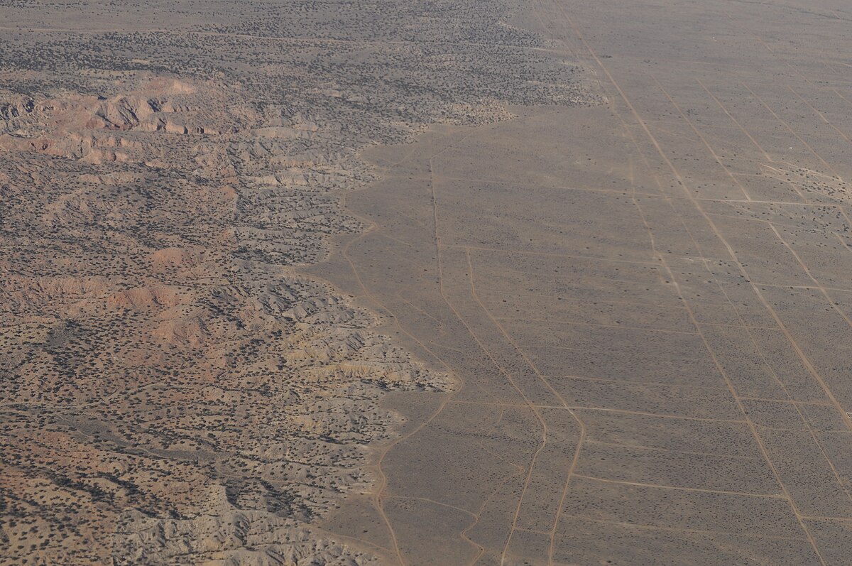 Aerial view where the hills begin west of Albuquerque, showing subdivision meeting foothills