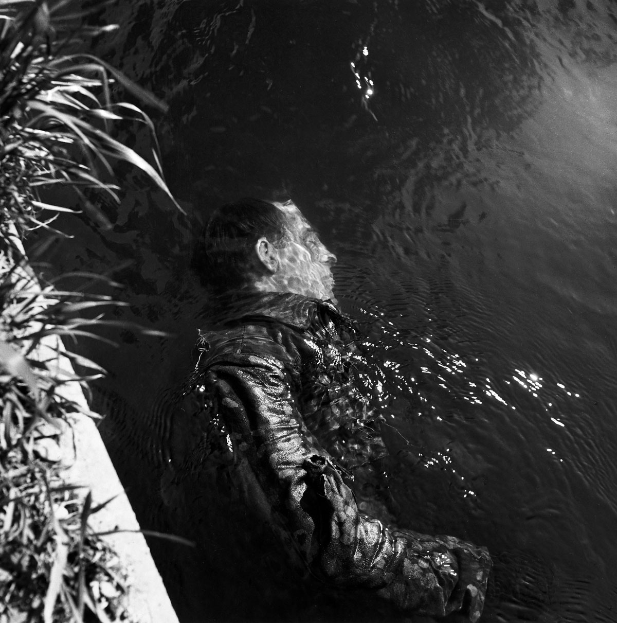 Dead SS Guard in Canal, Dachau, 1945 — Lee Miller