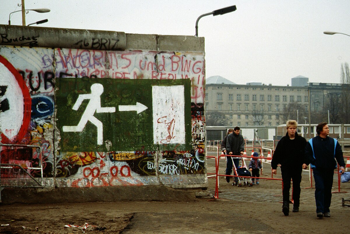 People walking through the fallen Berlin Wall, November 1989