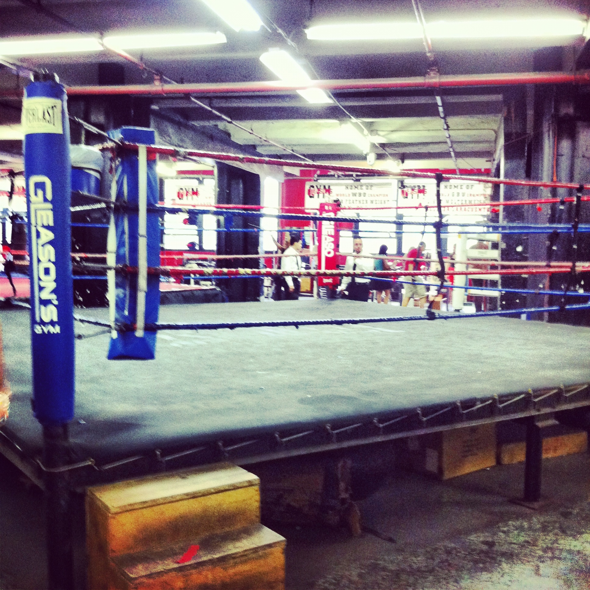 Boxing ring in a dimly lit gym — evoking Rio Branco's Academia de Boxe series