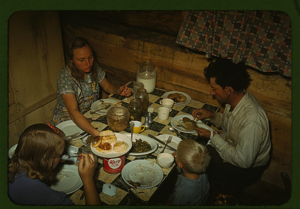 The Faro Caudill family eating dinner in their dugout, Pie Town, New Mexico, 1940 — Russell Lee, FSA/LOC