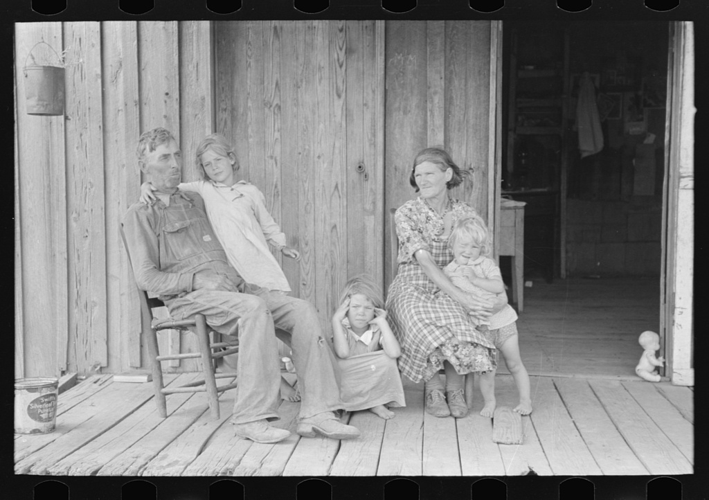 Grandparents with children on porch of sharecropper shack, Southeast Missouri Farms, 1938 — Russell Lee, FSA/LOC