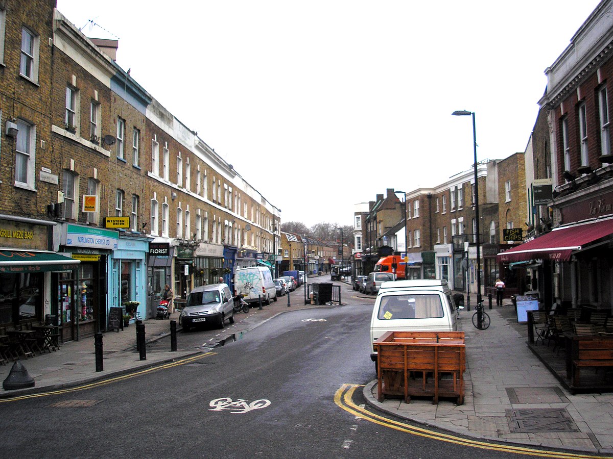 Broadway Market street scene in Hackney, London, evoking Stephen Gill's Hackney Wick series