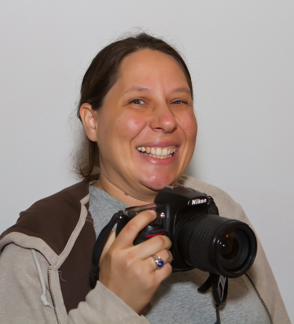 Zoe Strauss smiling with her Nikon camera, 2011
